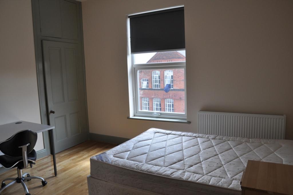 A bright and spacious double bedroom with a com...