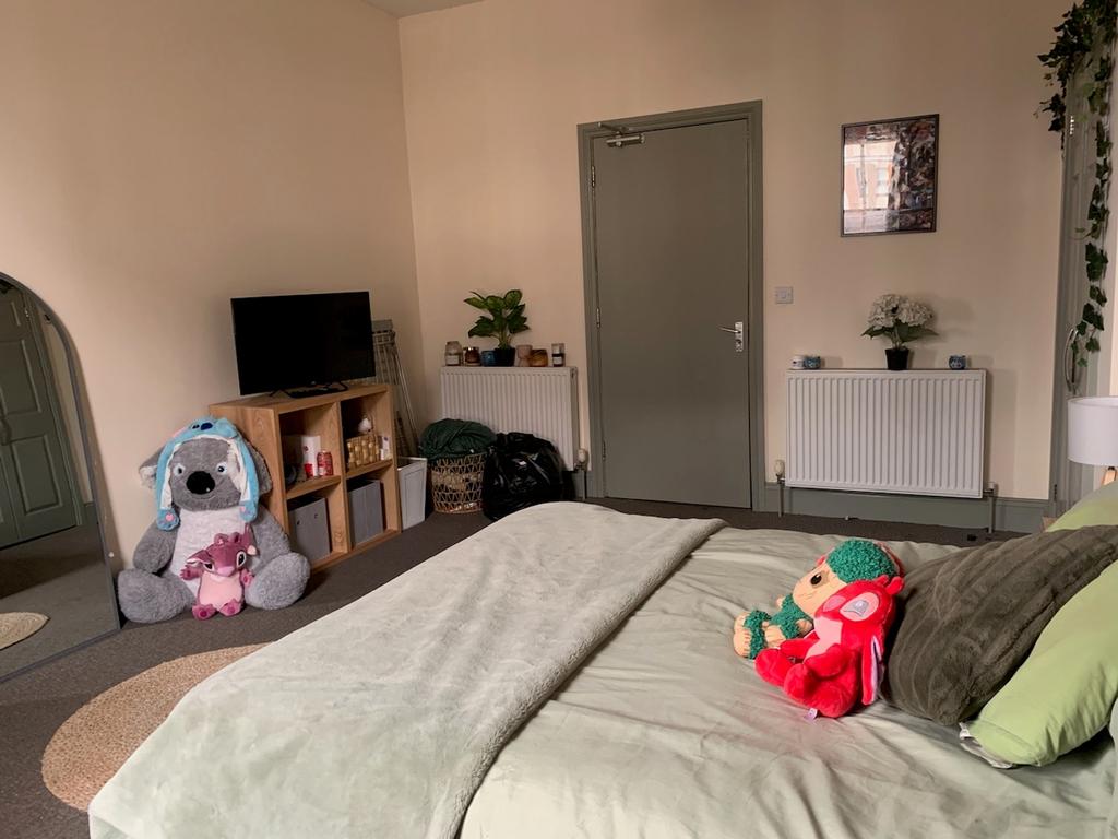 A spacious and inviting double bedroom featurin...