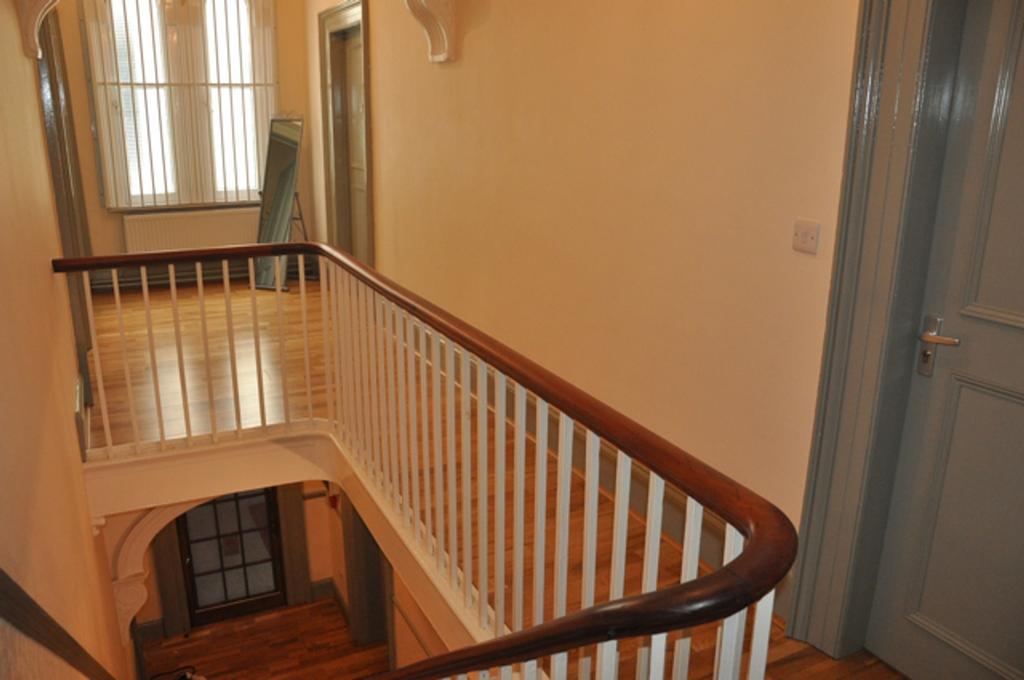 A spacious and tidy hallway with ample natural ...