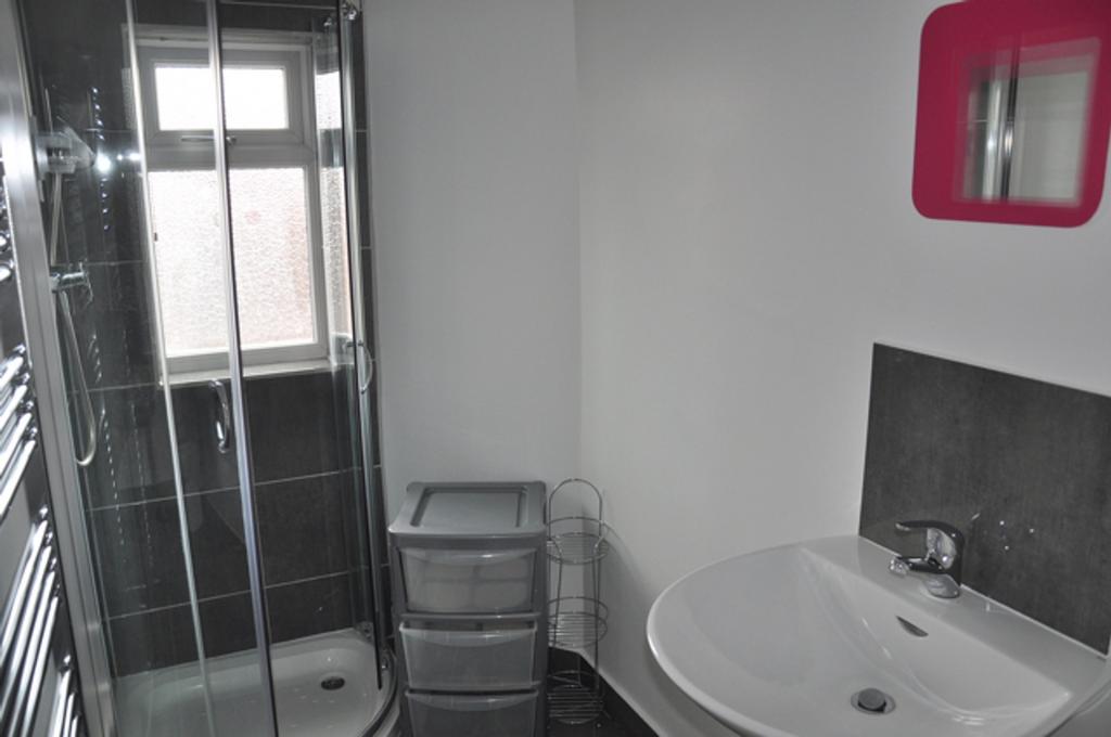 A modern bathroom featuring a sleek shower and ...