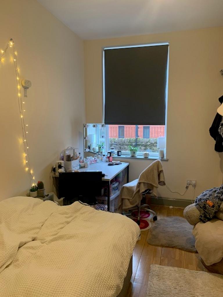 A cozy double bedroom with a well-organized stu...