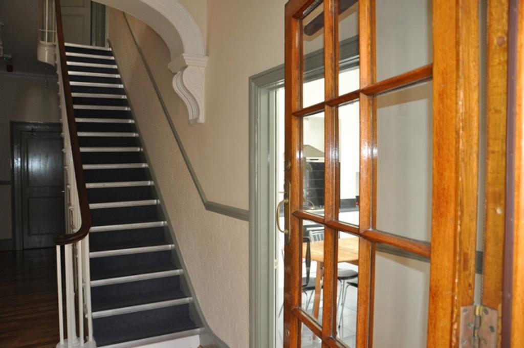 A tidy and inviting hallway leading to a spacio...