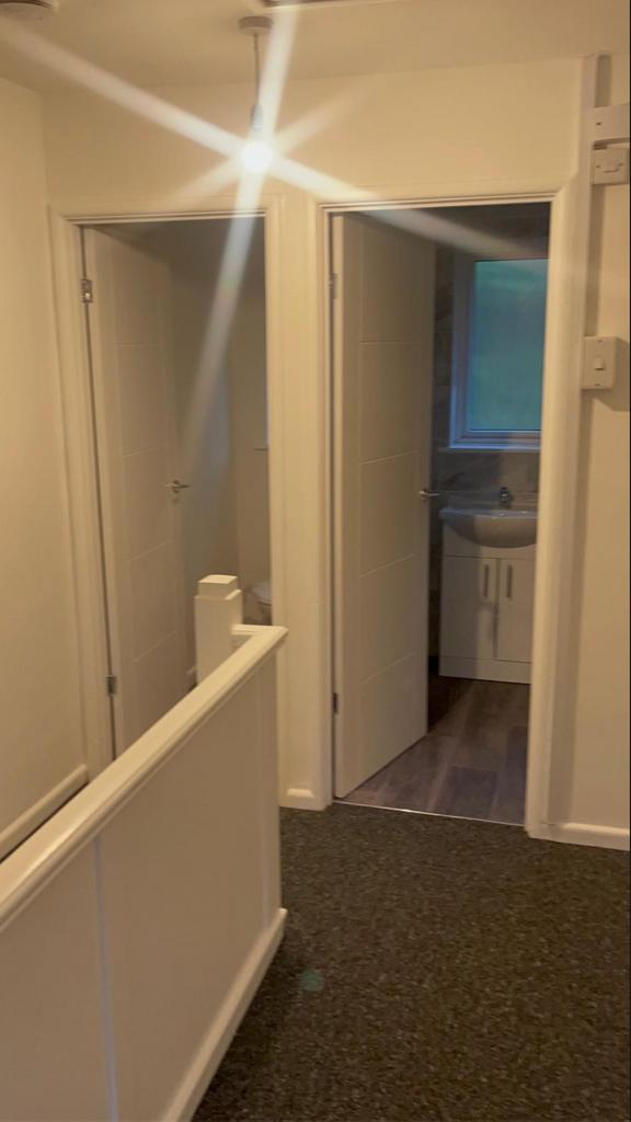 A tidy and functional hallway leading to variou...