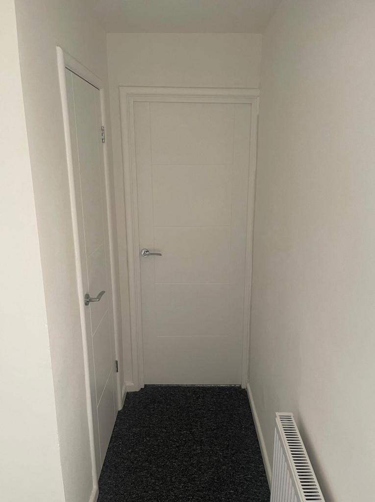 A well-maintained hallway with clean walls and ...