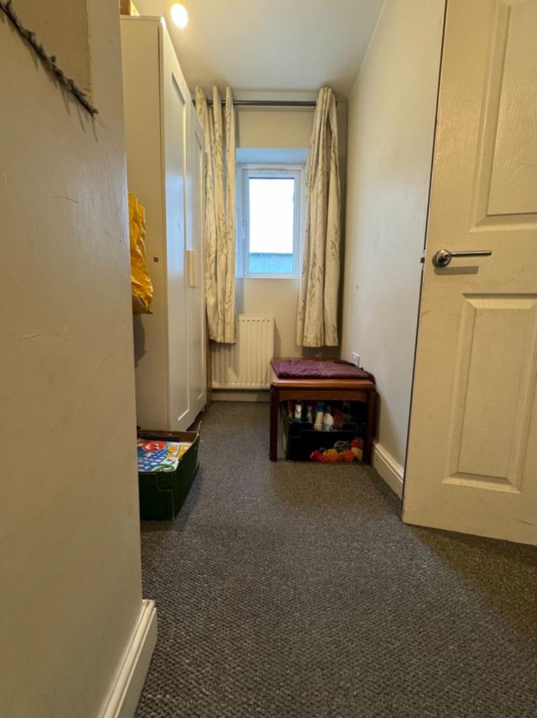 A tidy hallway with natural light and a welcomi...