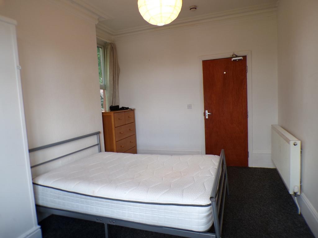 A bright and spacious double bedroom with ample...