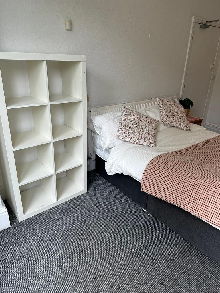 A cosy double bedroom featuring a comfortable b...