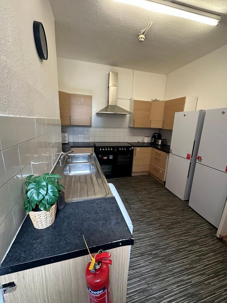 A functional kitchen featuring a double sink, a...