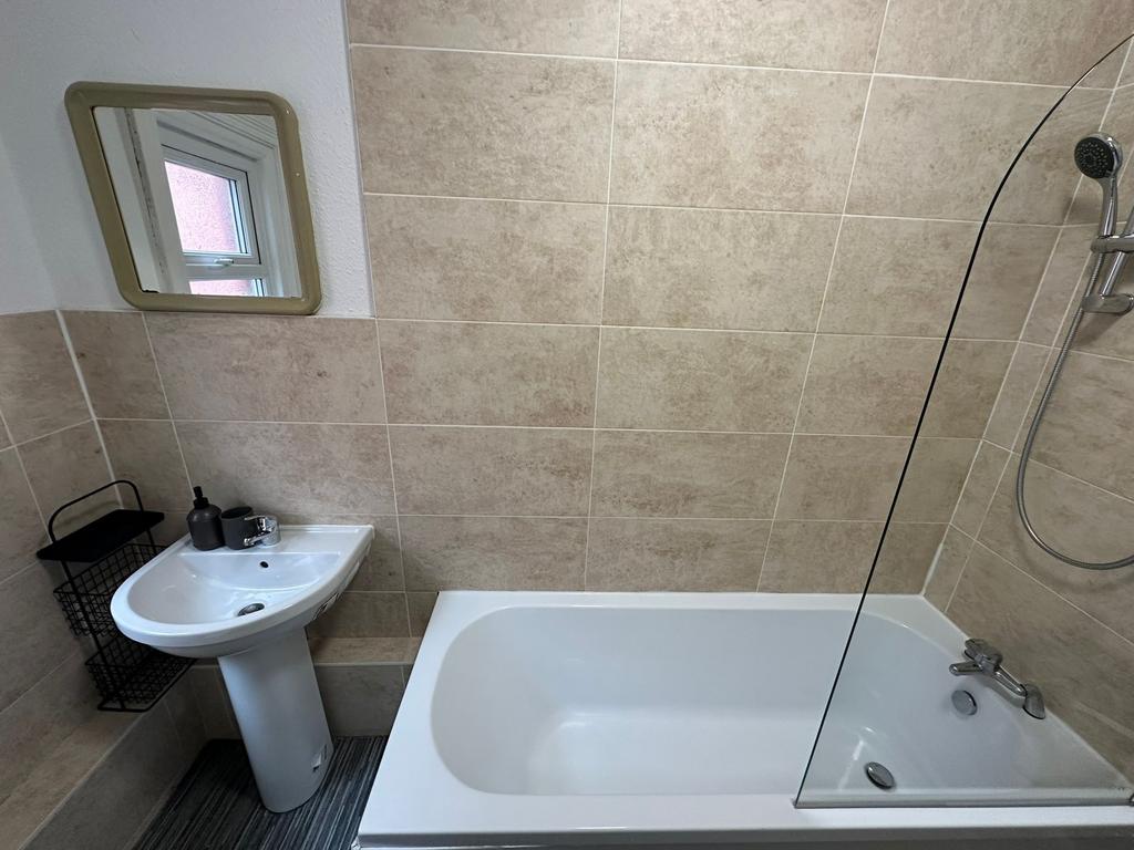 A clean and functional bathroom featuring a bat...