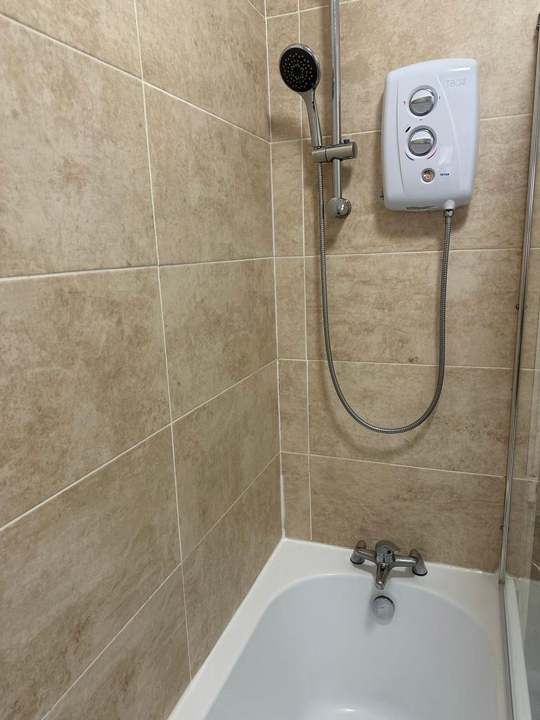 A clean and well-maintained shower area with be...