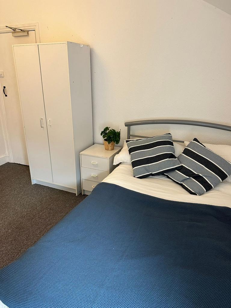 Cozy double bedroom with a comfortable bed, sty...