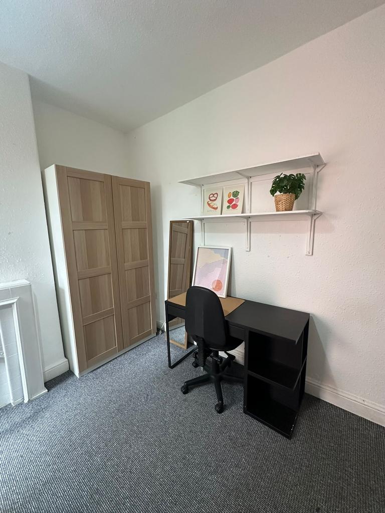 A tidy study space featuring a black desk with ...