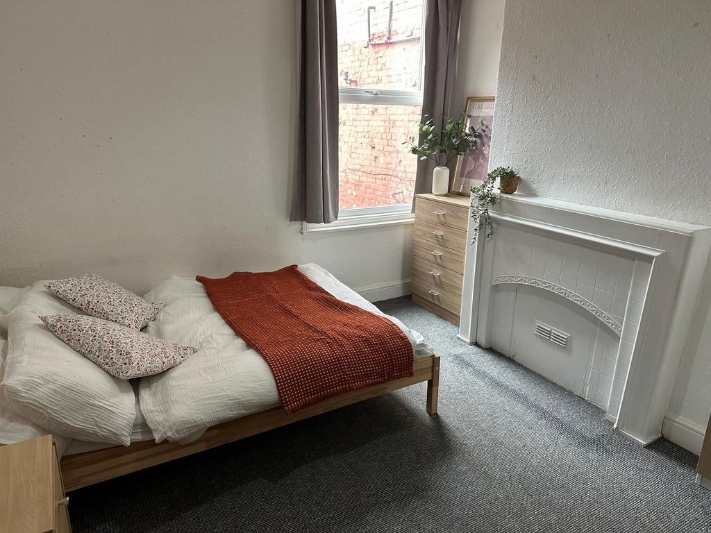 A bright and cozy double bedroom featuring a co...