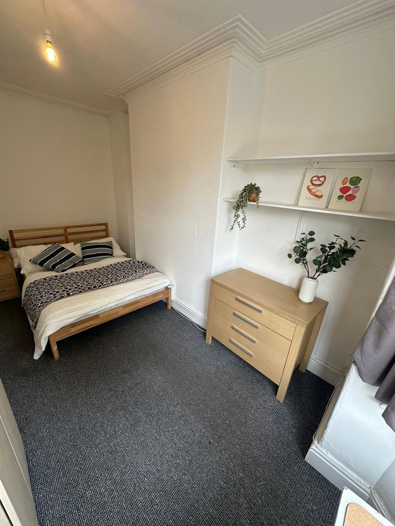 A cozy and well-maintained bedroom featuring a ...