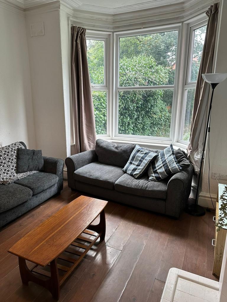 Bright and welcoming living room with large bay...