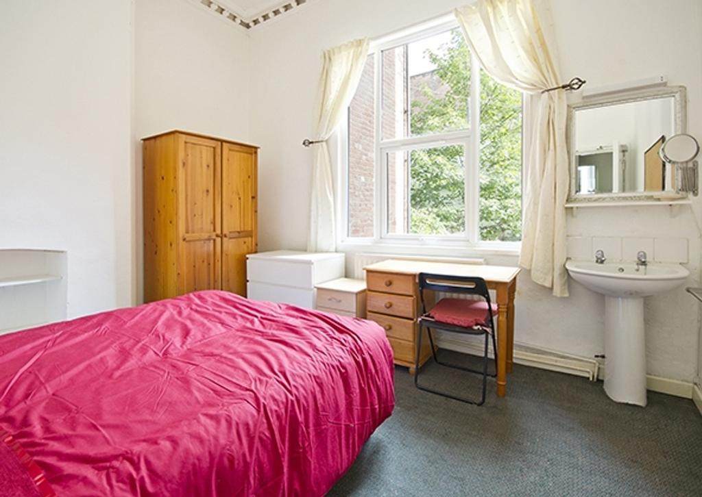 A bright and inviting double bedroom featuring ...