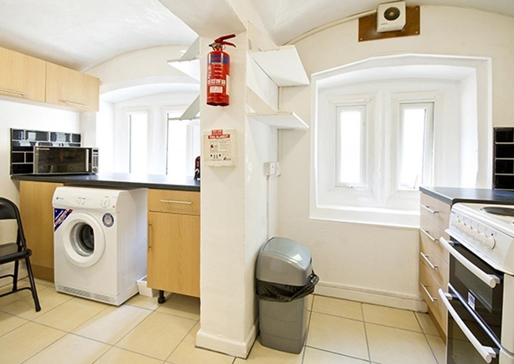 A bright and tidy kitchenette with modern appli...