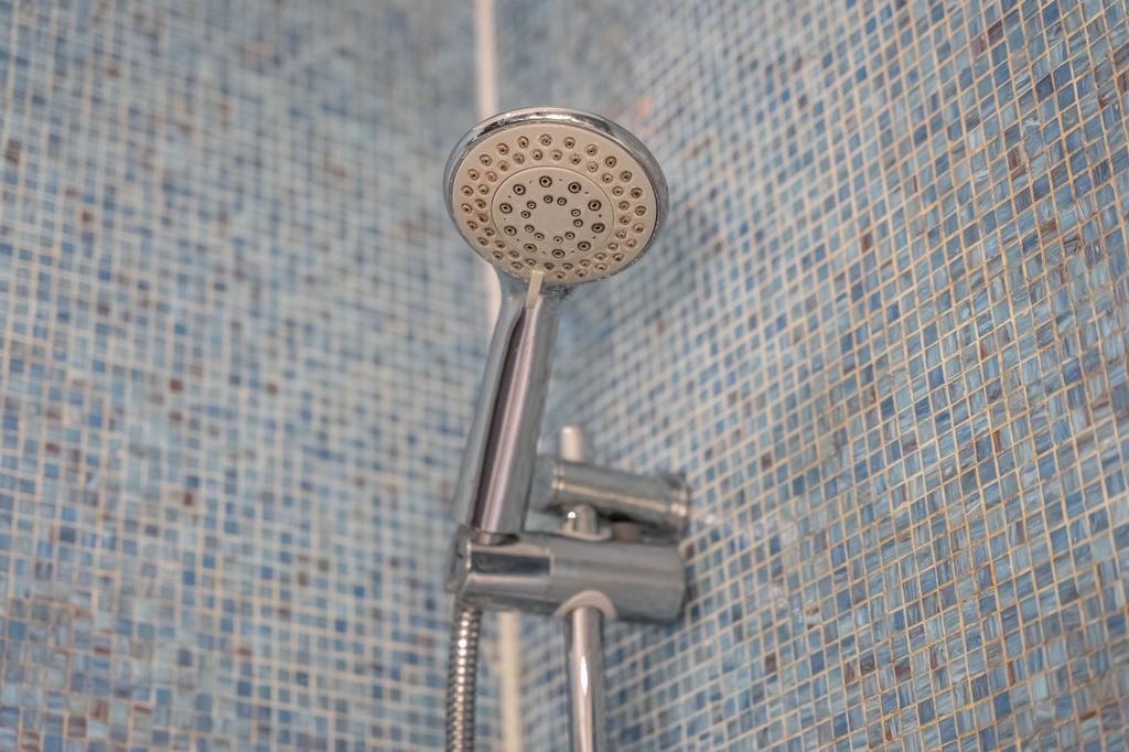 Close-up view of a modern chrome showerhead aga...