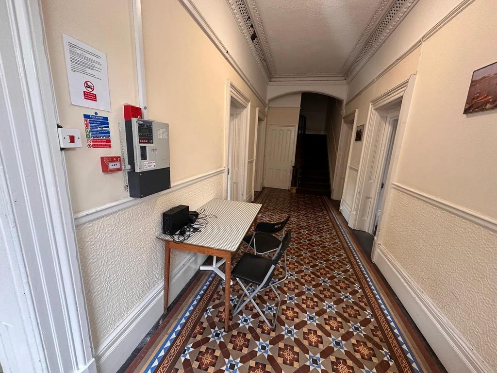 Bright, period hallway with decorative tiled fl...
