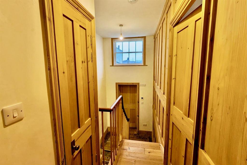 Eye catching wood panelling and upper sash window.