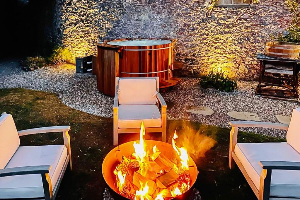 Swedish hot tub and fire pit in landscaped grounds