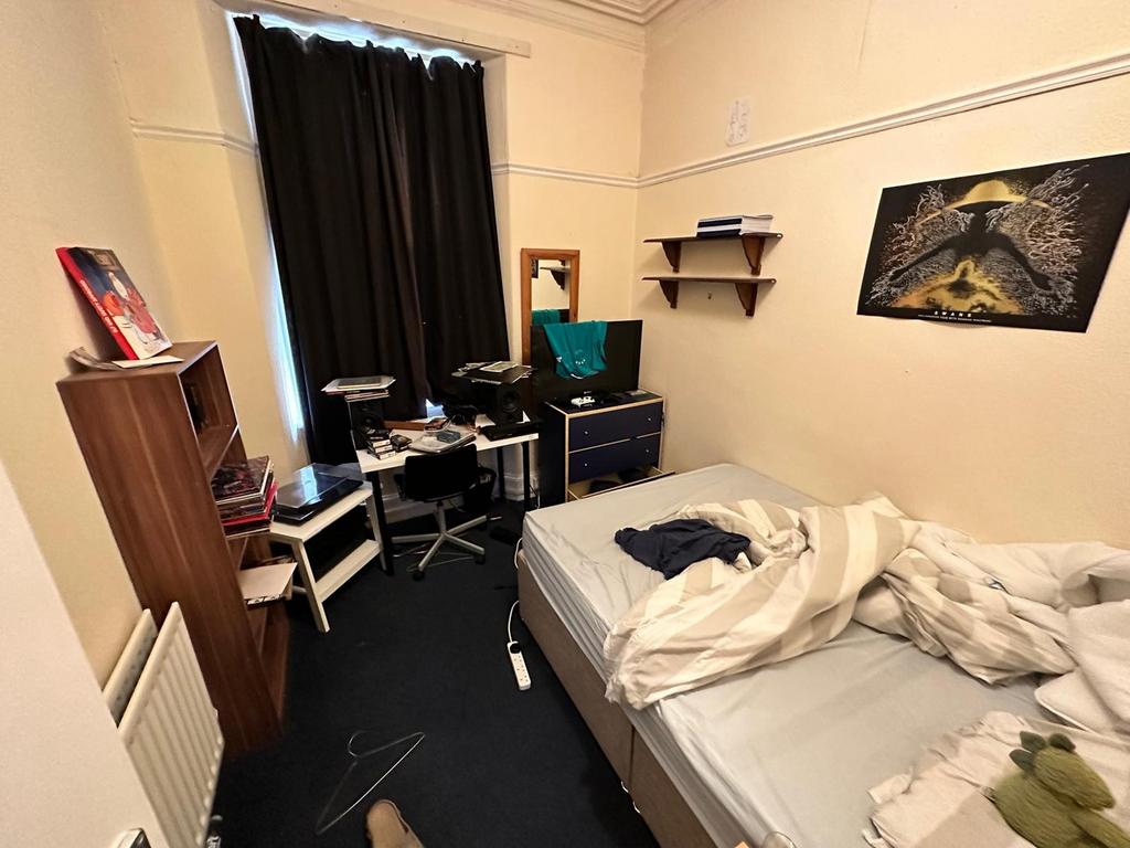 A cozy double bedroom with ample natural light ...