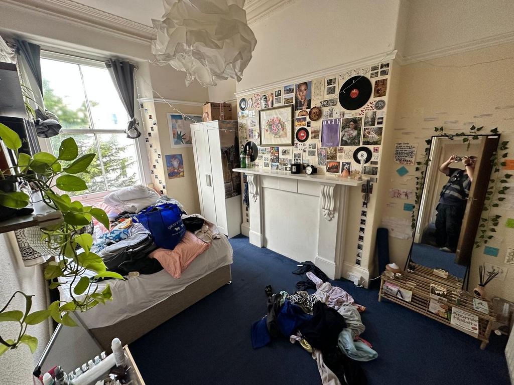 A cozy double bedroom filled with character and...