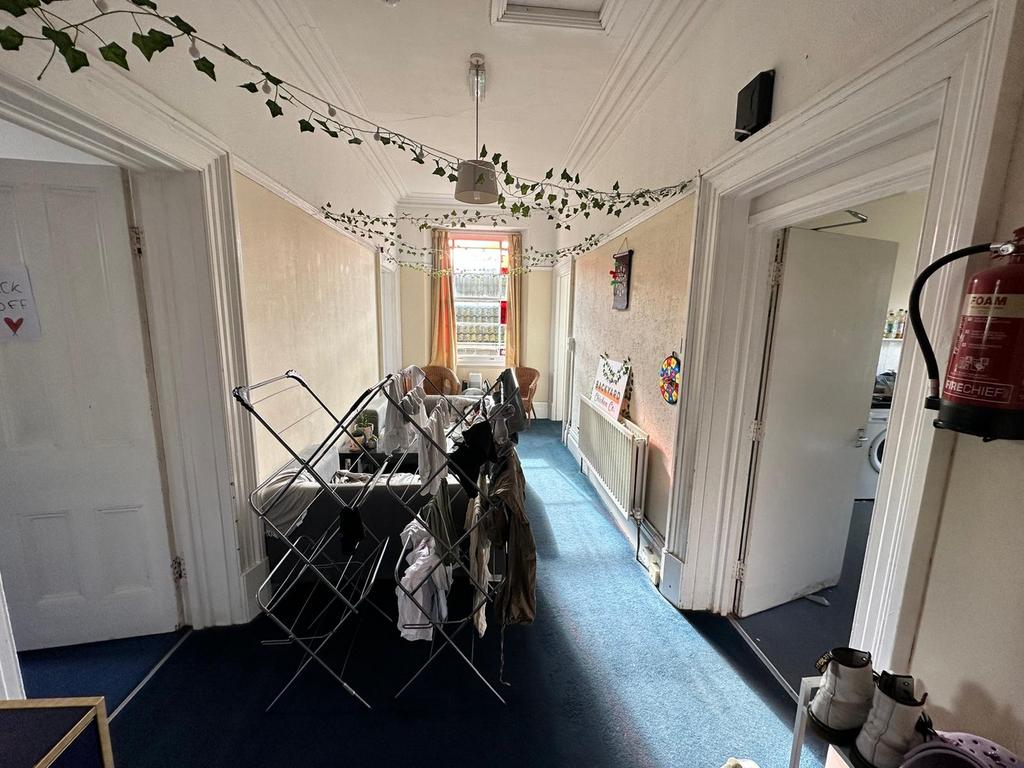 A spacious hallway with a cozy atmosphere, feat...
