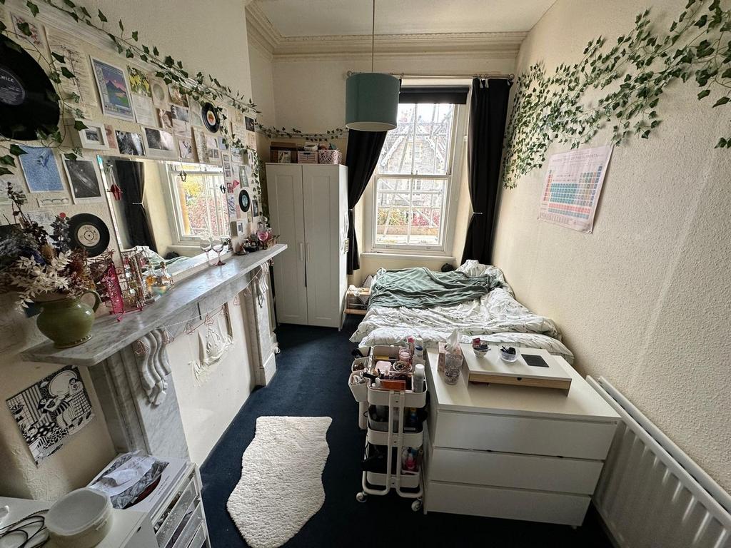 A cozy double bedroom filled with character, fe...