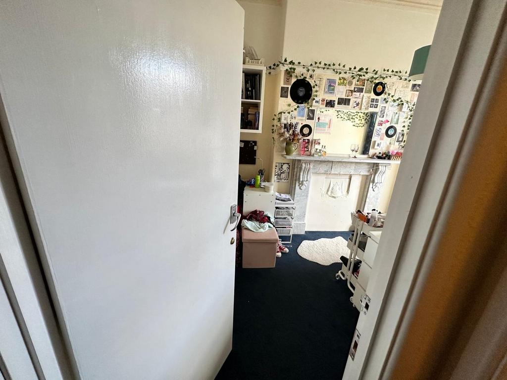 A cozy double bedroom with a personal touch, fe...