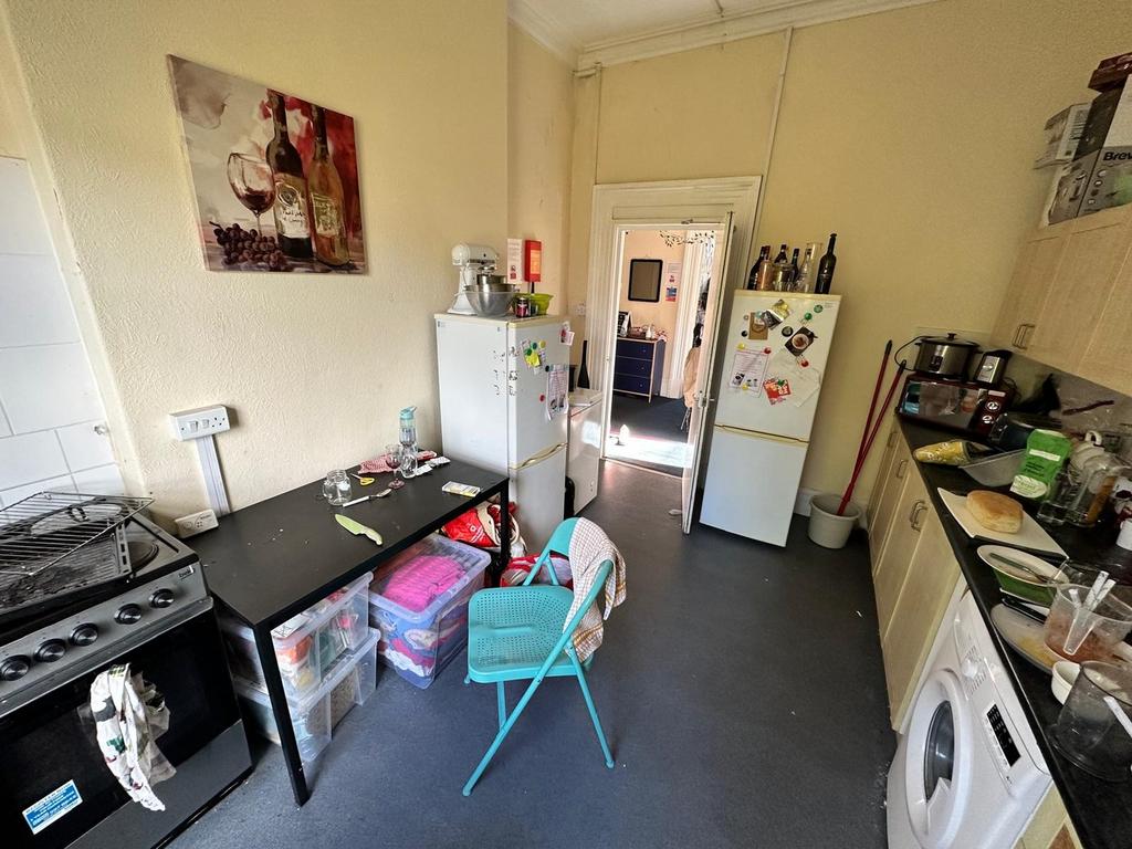 A cozy kitchenette with ample storage and a vib...