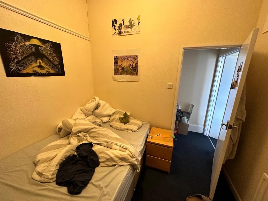 A cozy double bedroom with personal touches, re...