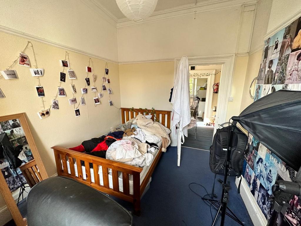 A cozy double bedroom with personal touches, of...