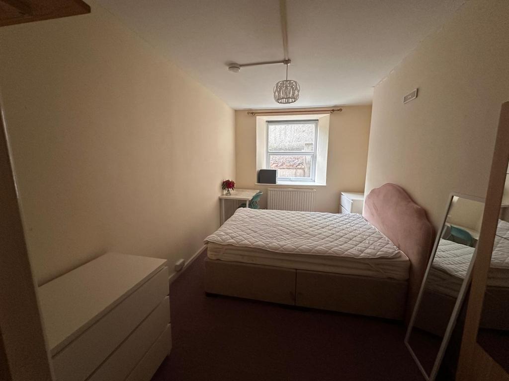 Bright, simply furnished double bedroom with a ...