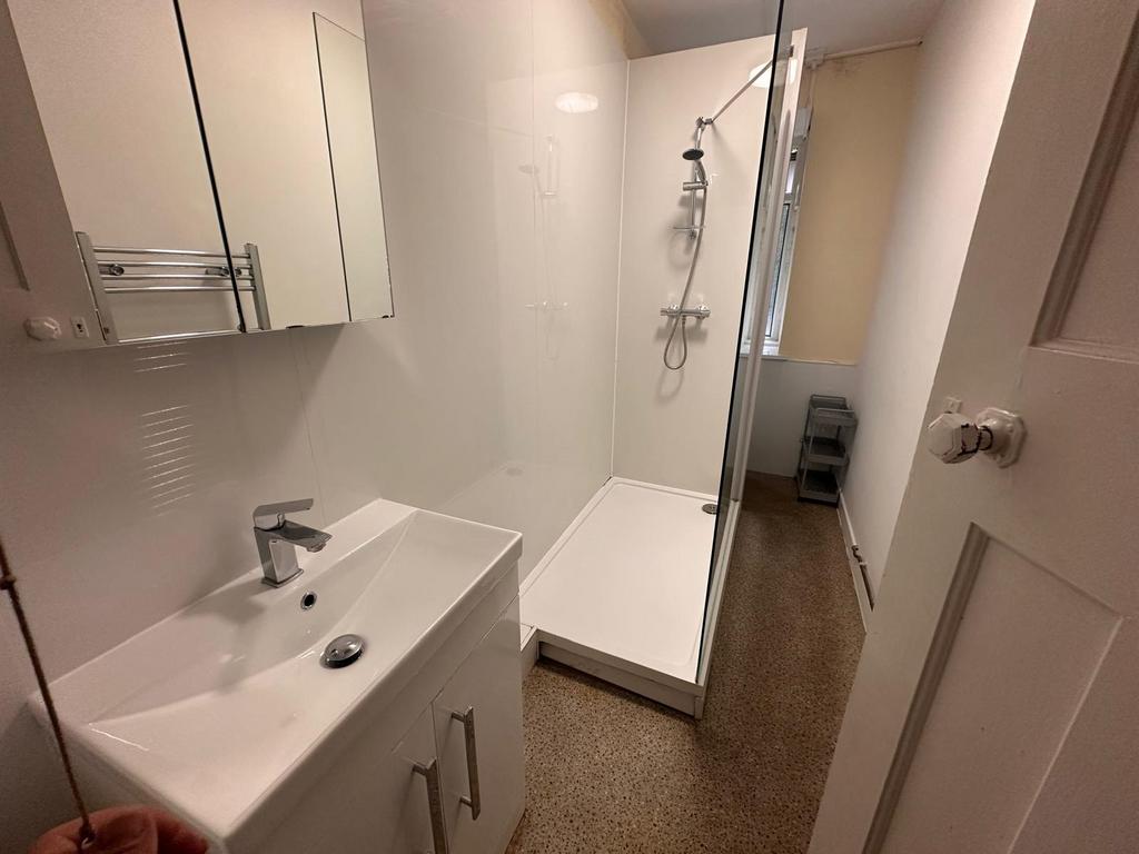 Bright, modern bathroom with a walk-in shower, ...