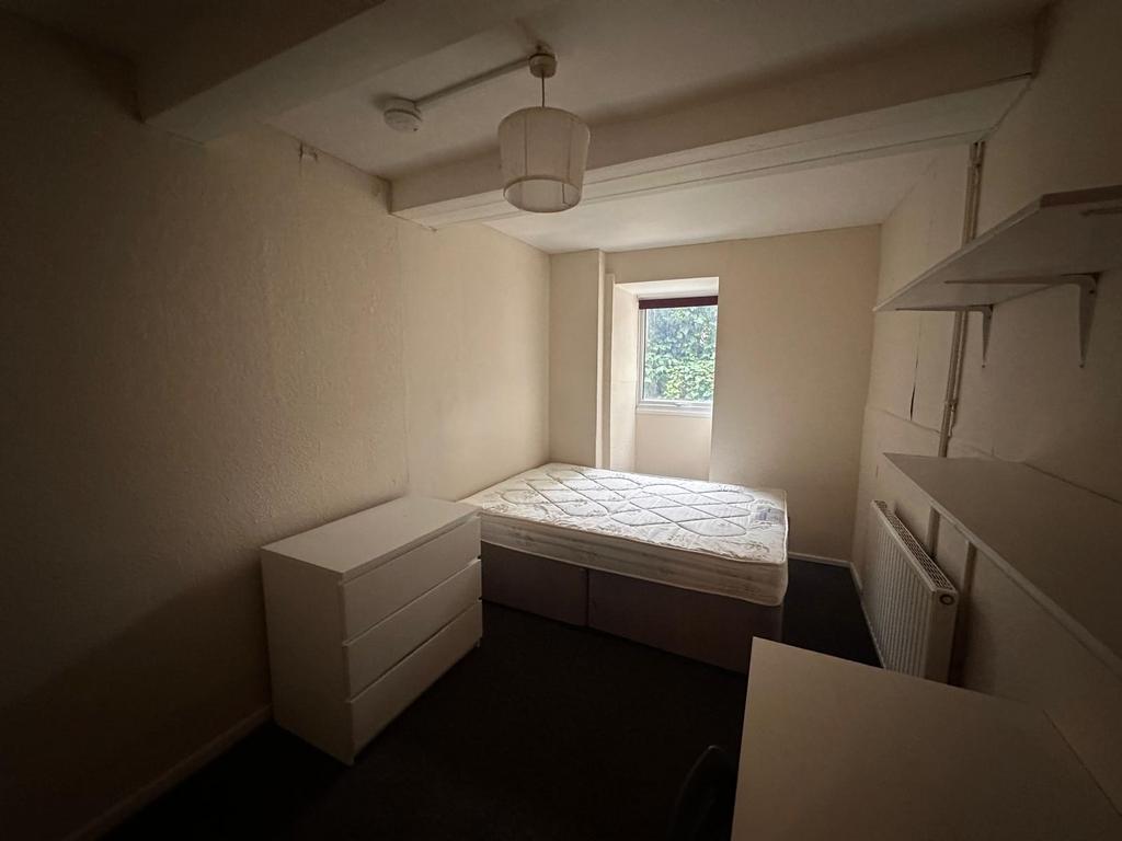 Well-presented bedroom with a double bed, chest...