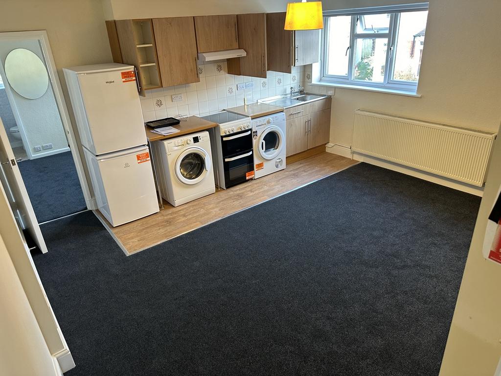 A spacious and bright kitchenette with modern a...
