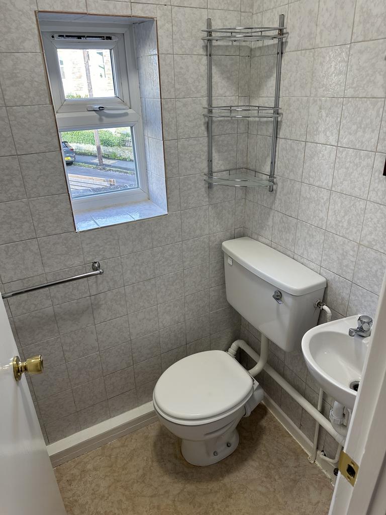 A tidy and functional single toilet with natura...
