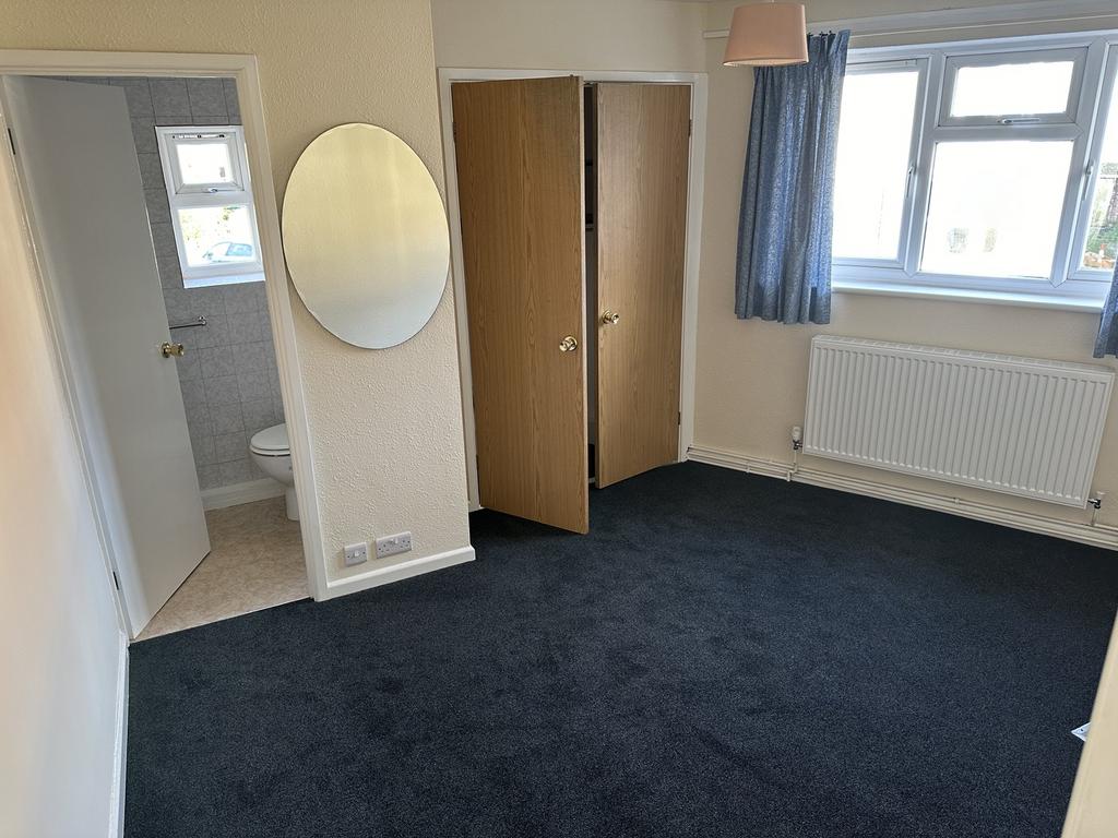 A spacious and bright double bedroom with a mod...