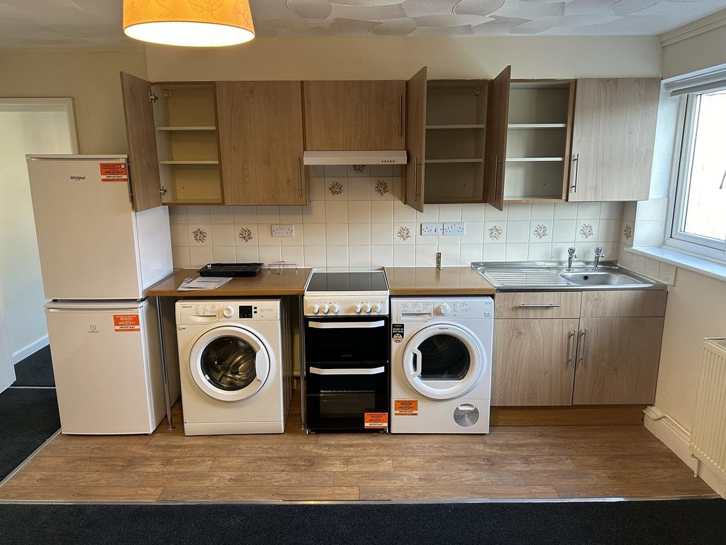 A modern kitchenette with essential appliances,...