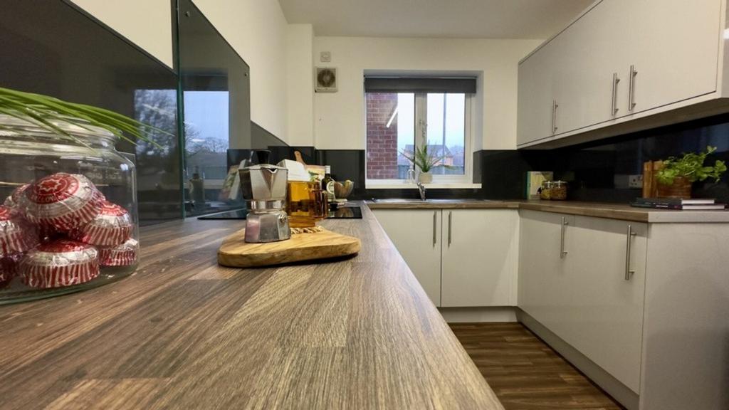 A bright and modern kitchenette with ample spac...