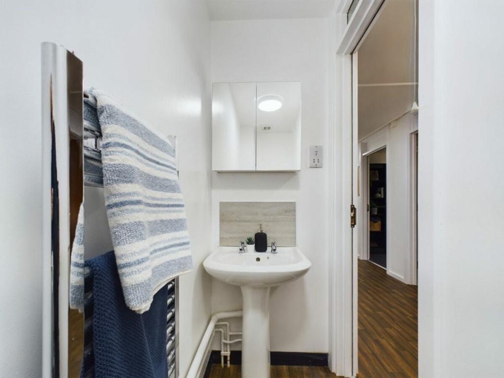 A clean and tidy bathroom featuring modern fixt...