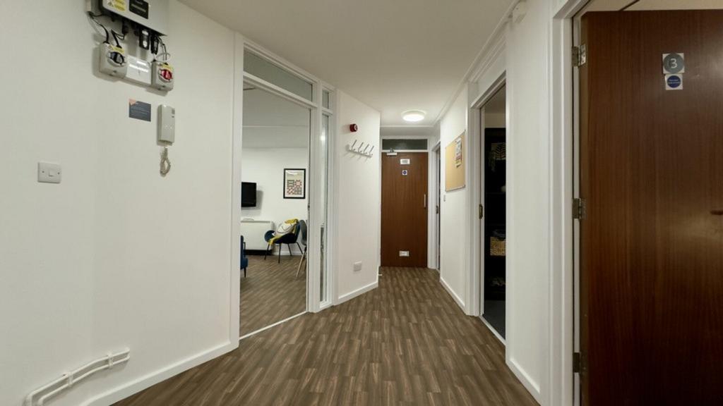 A well-maintained and spacious hallway with mod...