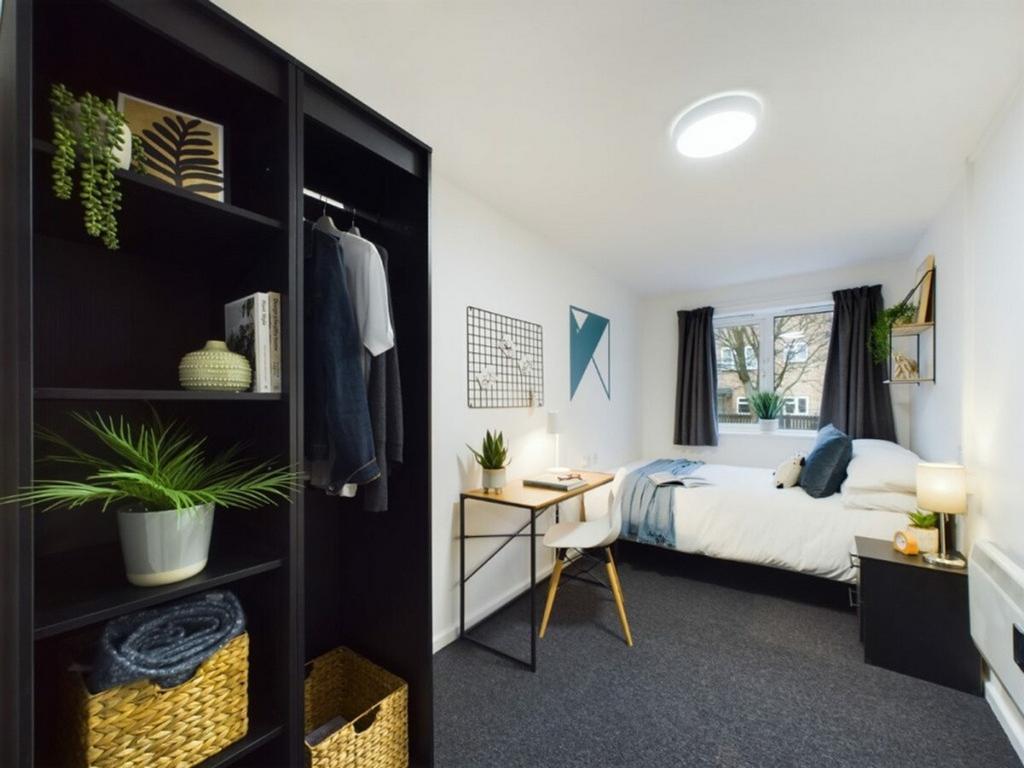 A spacious and well-lit double bedroom featurin...