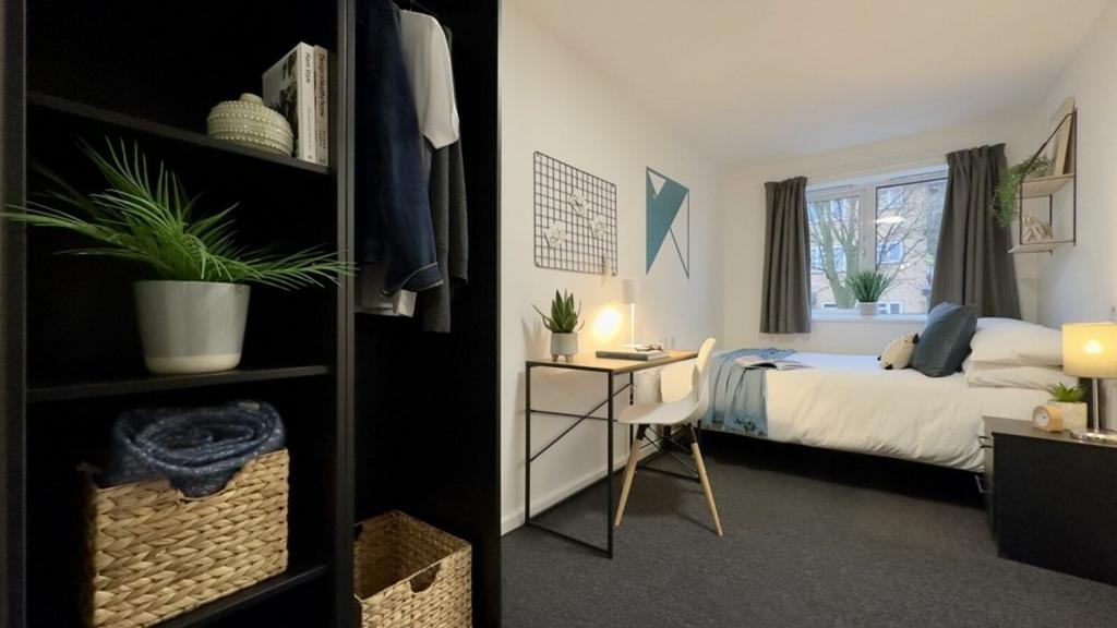 A bright and inviting double bedroom with styli...