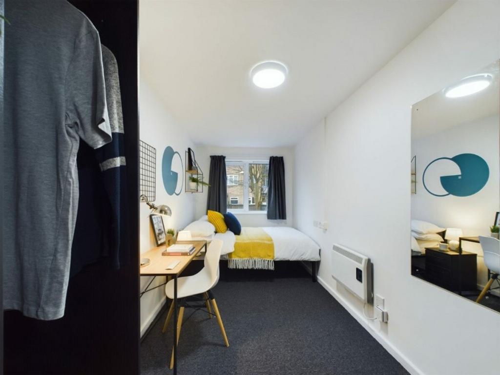A stylish and well-lit double bedroom featuring...