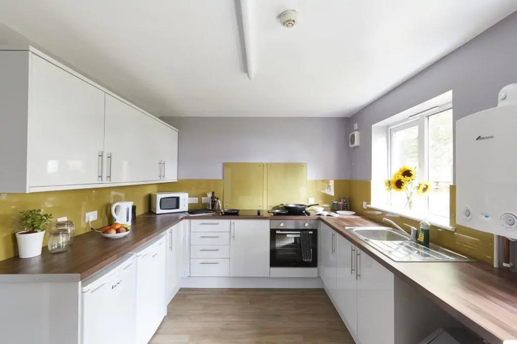 A bright and modern kitchen featuring ample cou...
