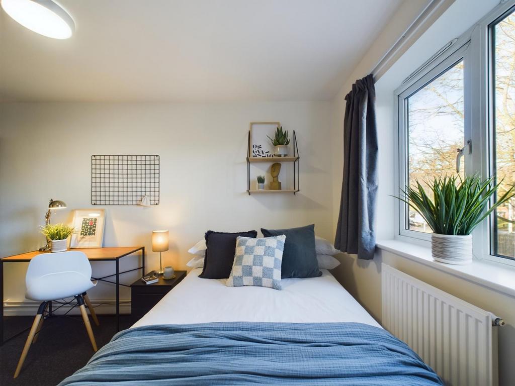 A bright and inviting double bedroom featuring ...