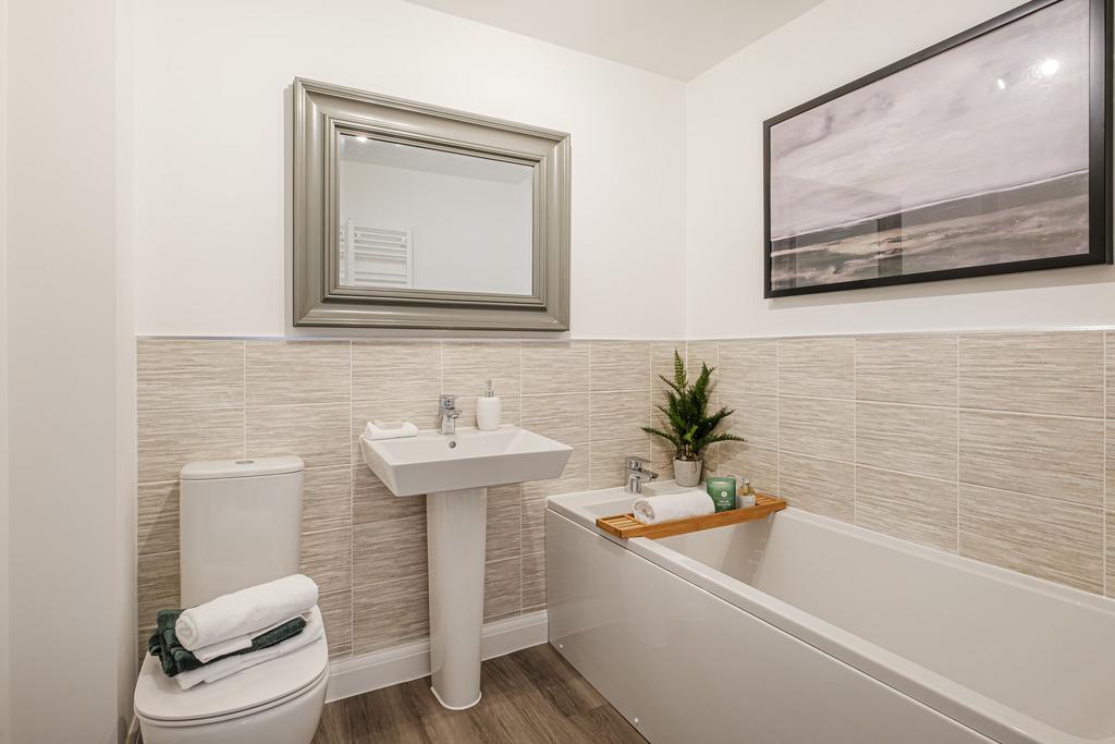 Hurst bathroom with half tiled walls