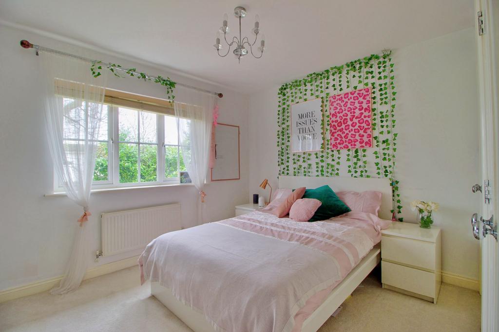 Bedroom with fitted wardrobes and garden view